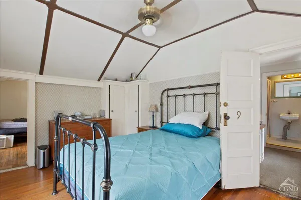 a bedroom with furniture and wooden floor