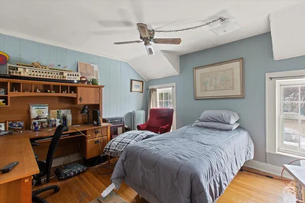 a bedroom with bed and windows