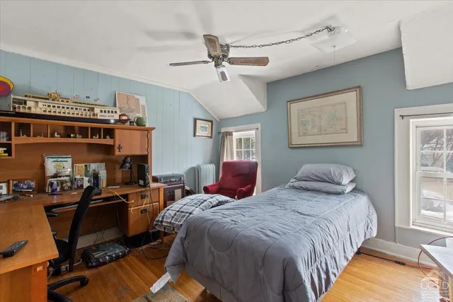 a bedroom with bed and windows