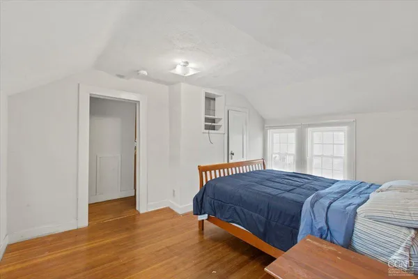 a bedroom with a bed and window
