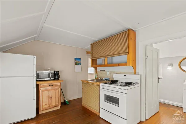 a kitchen with a stove a refrigerator and a stove top oven