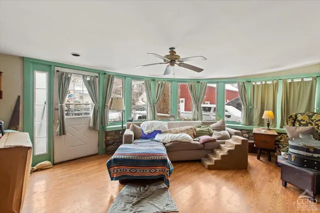 a living room with furniture and large windows