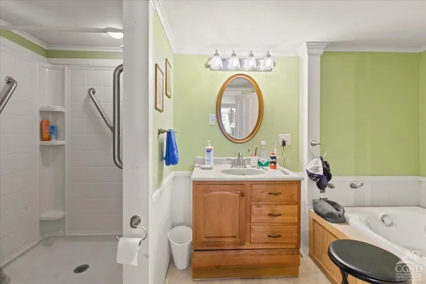 a bathroom with a toilet sink vanity tub and shower