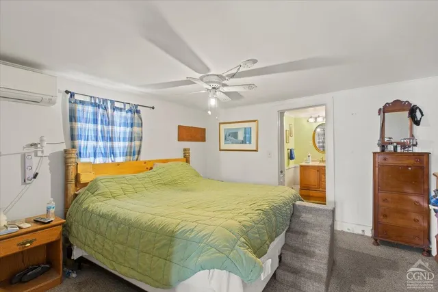 a bed sitting in a bedroom next to a window and a lamp