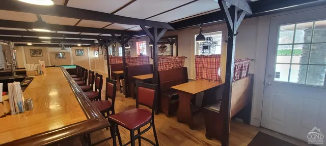 a view of a livingroom with furniture window and wooden floor
