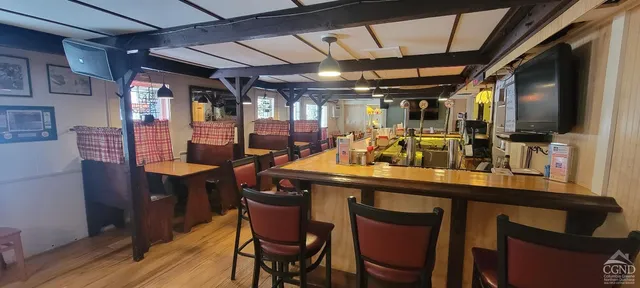 a dining table with chairs and wooden floor