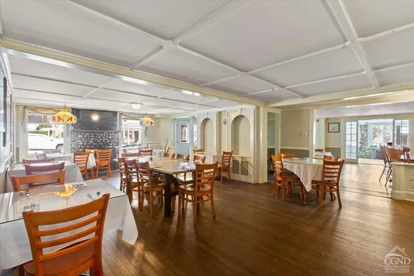 a view of a dining room with furniture window and wooden floor