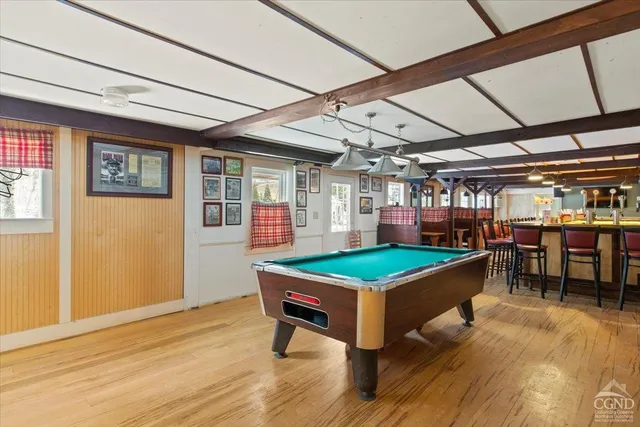a room with furniture and pool table