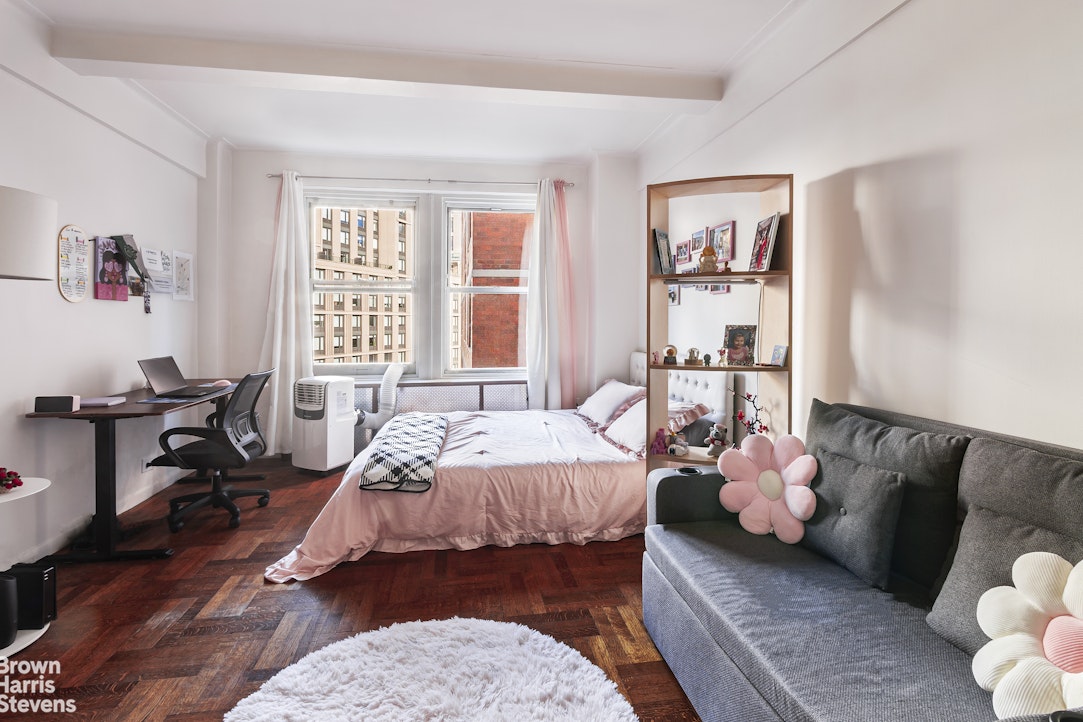 433 West 34th Street, Unit 5M Manhattan, NY 10001 - Photo 2 of 13 a bedroom with a bed couch and a window