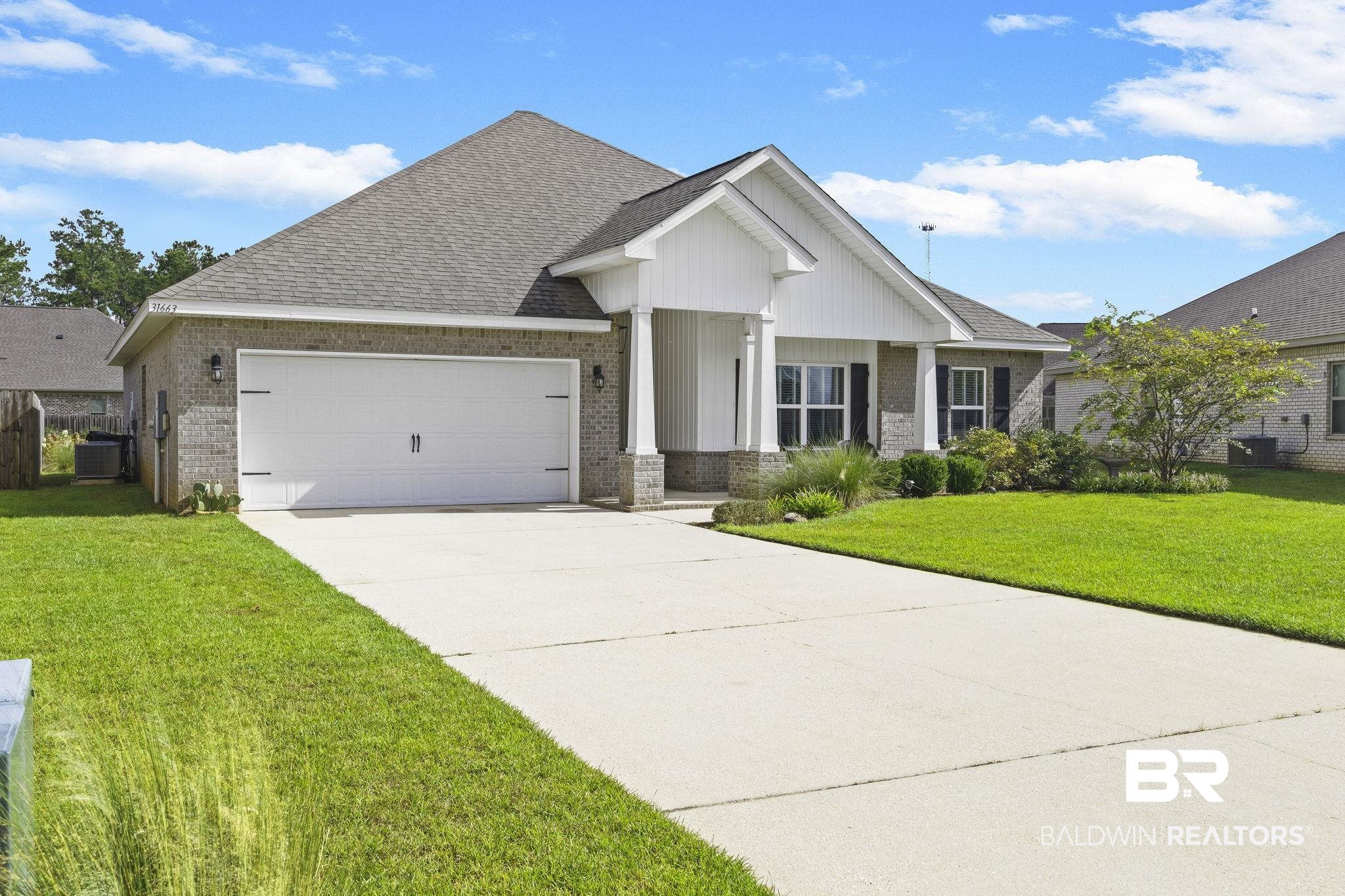 31663 Kestrel Loop Daphne, AL 36527 - Photo 4 of 86 View of front facade featuring central AC, a garage, and a front lawn