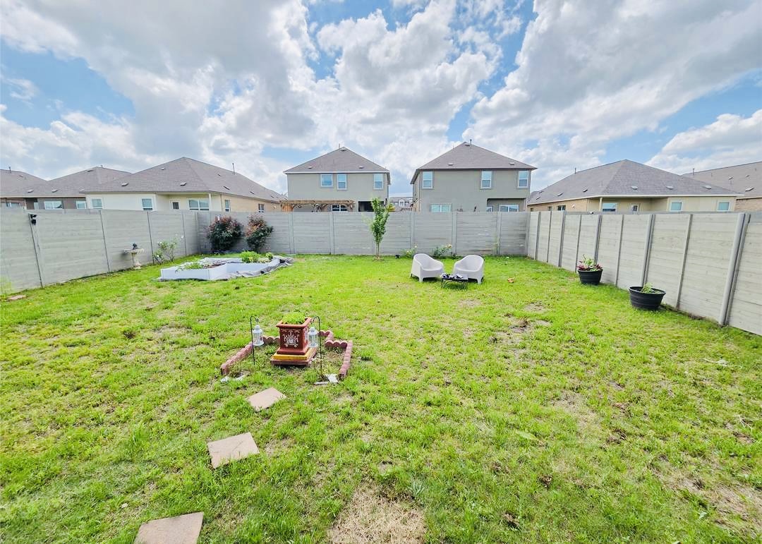 208 Wolf Springs Road Georgetown, TX 78628 - Photo 24 of 32 A fenced backyard offers a private outdoor sanctuary, perfect for quiet enjoyment.