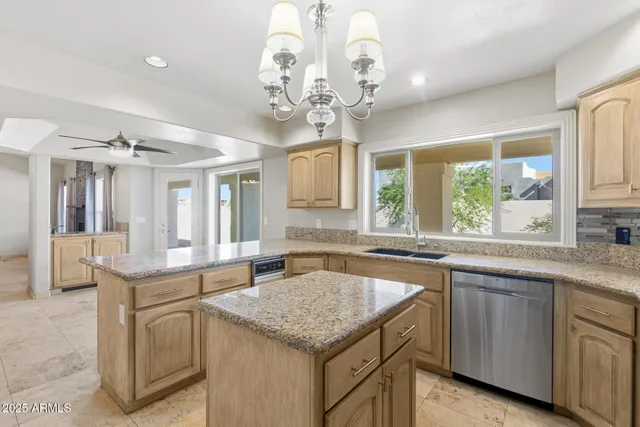 a view of a hallway with wooden floor and a living room