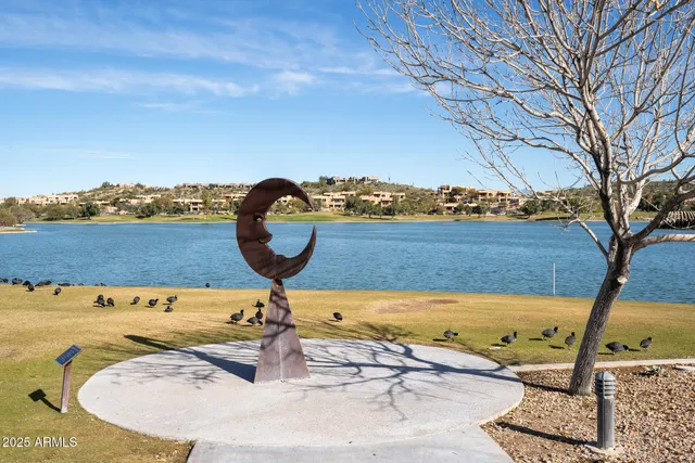 a kitchen with kitchen island granite countertop a refrigerator and microwave