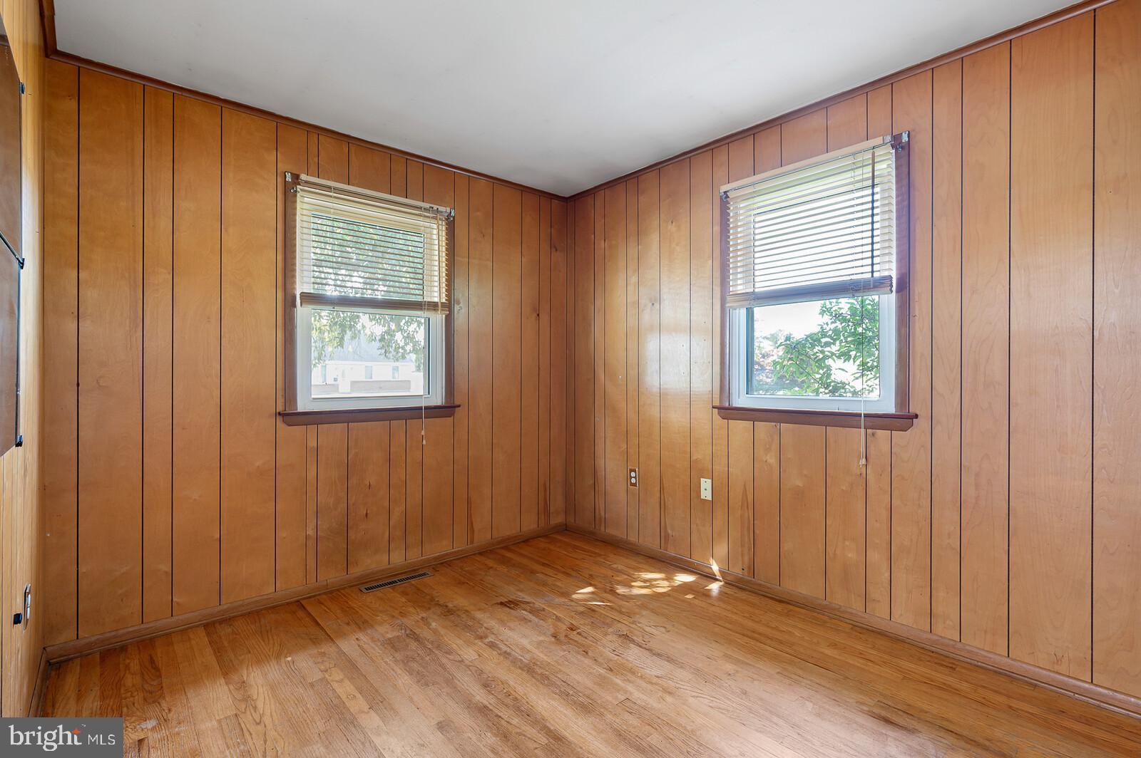 212 North Brownleaf Road Newark, DE 19713 - Photo 3 of 10 an empty room with wooden floor and windows