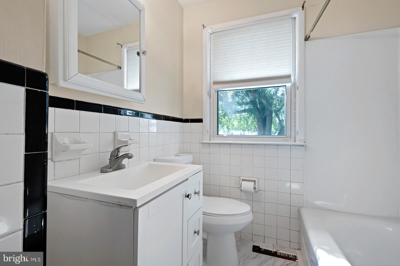 212 North Brownleaf Road Newark, DE 19713 - Photo 4 of 10 a bathroom with a sink toilet and mirror