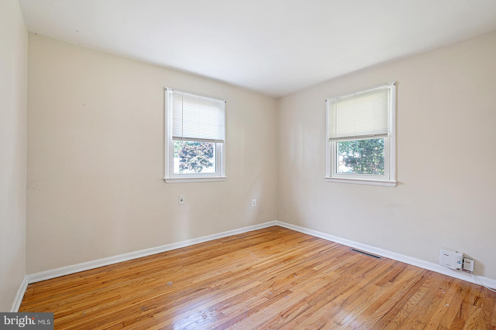 212 North Brownleaf Road Newark, DE 19713 - Photo 6 of 10 an empty room with wooden floor and windows