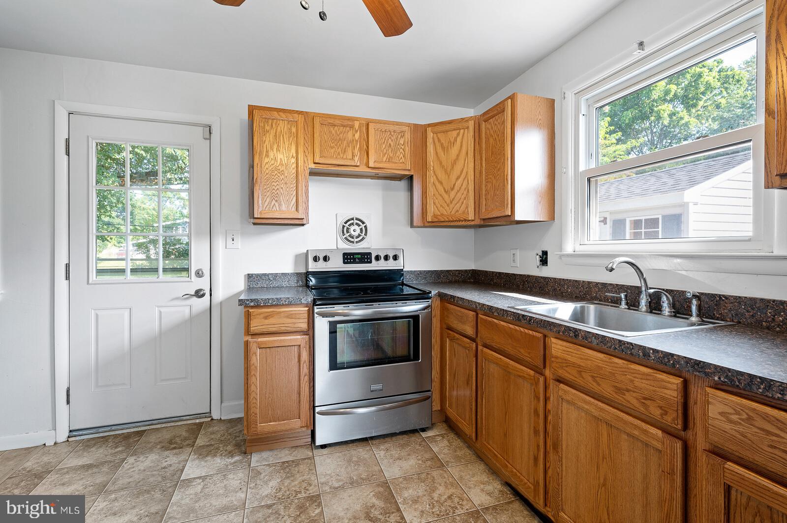 212 North Brownleaf Road Newark, DE 19713 - Photo 9 of 10 a kitchen with stainless steel appliances granite countertop a sink a stove and a window