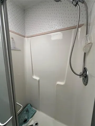 a bathroom with a shower and a mirror
