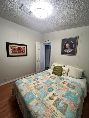 a bedroom with a large bed and a view of bathroom