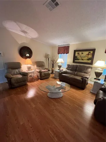 a living room with furniture and a lamp