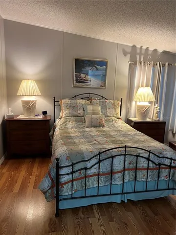 a bedroom with a bed a mirror and lamp