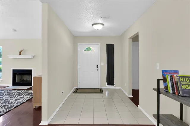 a view of a livingroom with wooden floor and a fireplace
