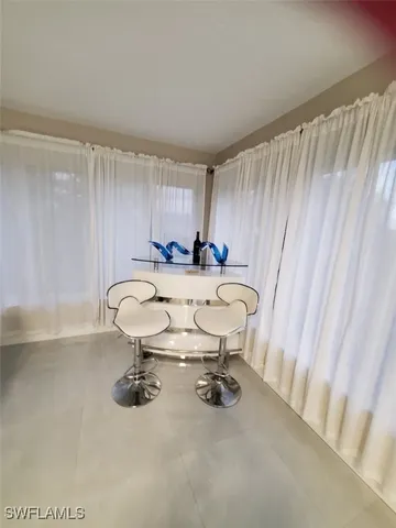 a view of a room with a table and chairs