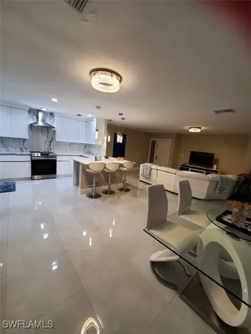a living room with furniture and a kitchen