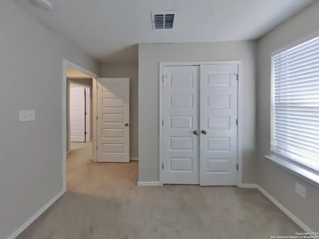 an empty room with windows closet and empty room