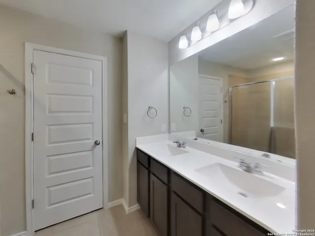 a bathroom with a sink double vanity and a mirror