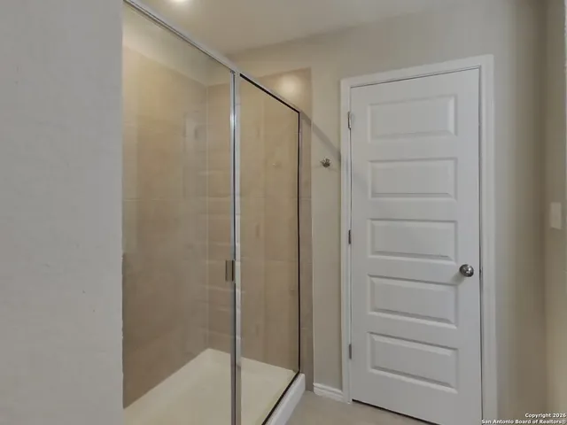 a bathroom with a shower and a sink