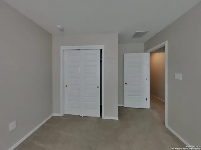 an empty room with closet area