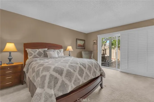 a bedroom with a bed and painting on the wall