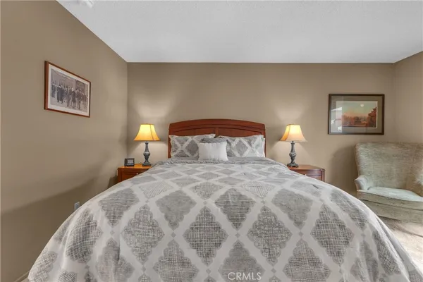 a spacious bedroom with a bed and a dresser