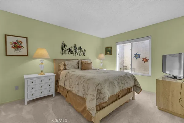 a bedroom with a bed and a mirror