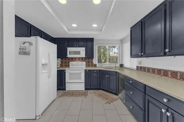 a kitchen with a refrigerator sink and cabinets