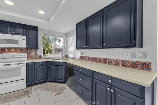 a kitchen with a sink stove and microwave