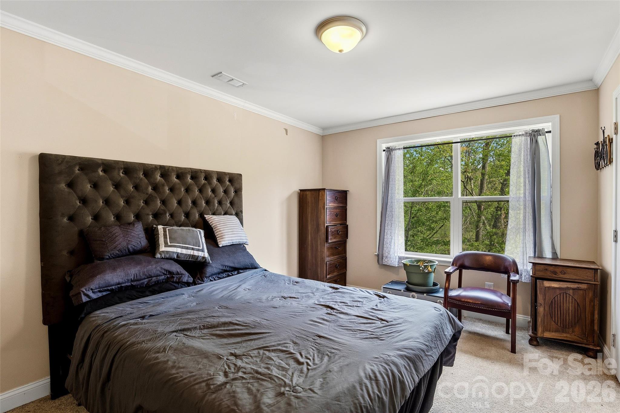 26 Brigman Road Weaverville, NC 28787 - Photo 20 of 27 a bedroom with a bed and a large window