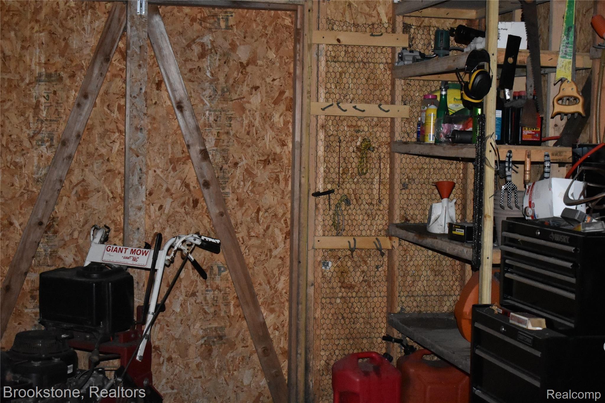 405 Baldwin Ridge Oxford, MI 48371 - Photo 5 of 54 ATTACHED TO THE BACK OF THE "OVERSIZED" 8 CAR GARAGE IS A LARGE TOOL ROOM (8X16). THE TOOL ROOM CAN BE ENTERED FROM THE EXTERIOR OR FROM THE LARGE PAVILION (36X52)