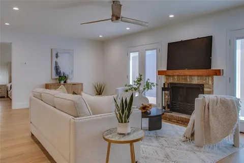 a living room with furniture a fireplace and a flat screen tv