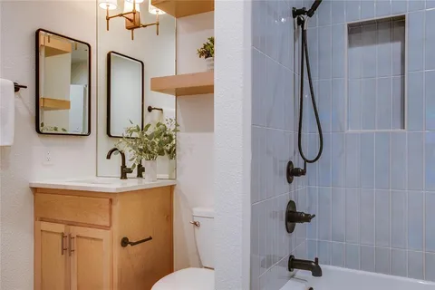 a spacious bedroom with a bed and a flat screen tv