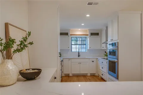a kitchen with a sink and a stove