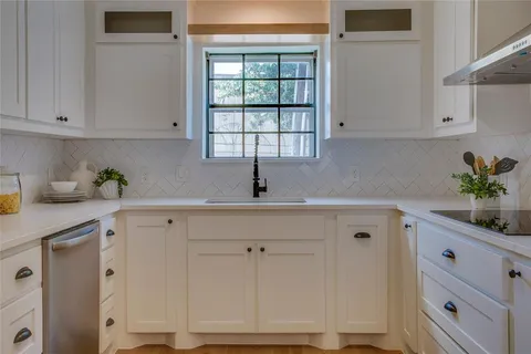 a kitchen with cabinets and window