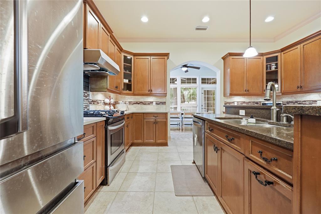 9255 Southwest 29 Avenue Gainesville, FL 32608 - Photo 14 of 79 a kitchen with stainless steel appliances granite countertop a sink counter space cabinets and a large window