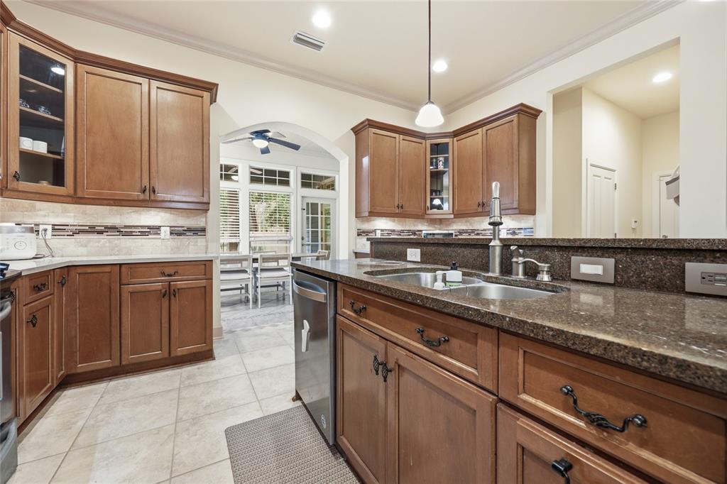 9255 Southwest 29 Avenue Gainesville, FL 32608 - Photo 15 of 79 a kitchen with stainless steel appliances granite countertop a sink stove and cabinets