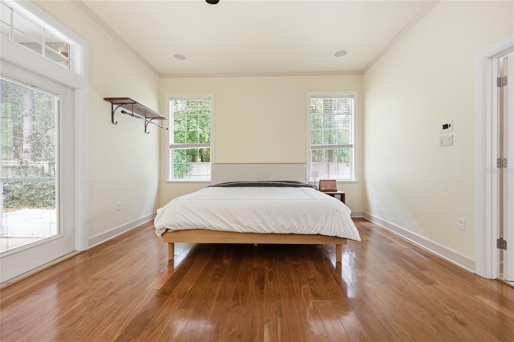 9255 Southwest 29 Avenue Gainesville, FL 32608 - Photo 26 of 79 a bed sitting in a spacious bedroom next to a window