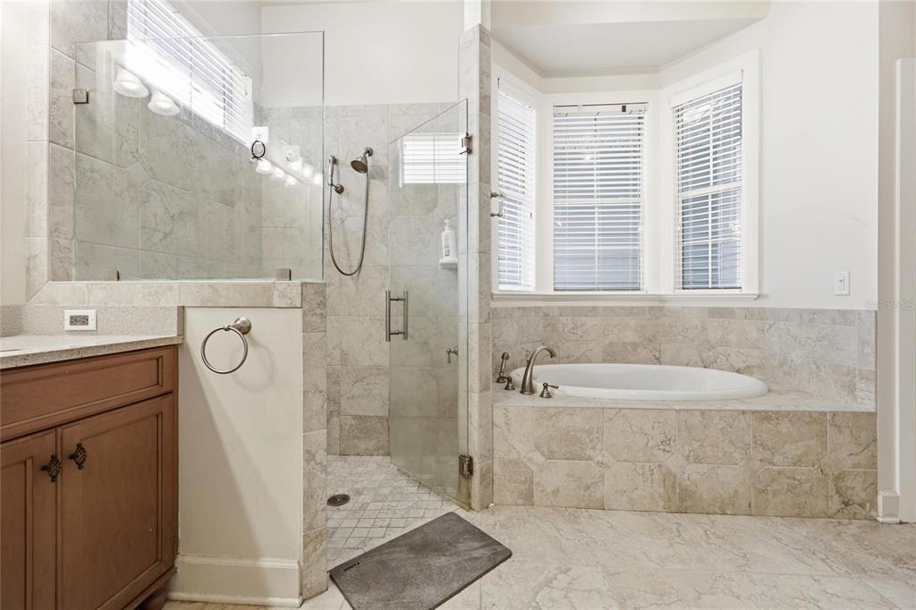 9255 Southwest 29 Avenue Gainesville, FL 32608 - Photo 32 of 79 a bathroom with a tub sink and mirror