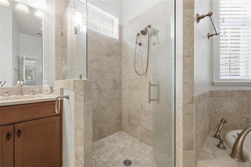 9255 Southwest 29 Avenue Gainesville, FL 32608 - Photo 33 of 79 a bathroom with a shower sink and mirror