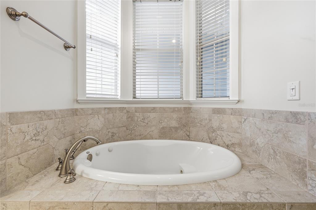 9255 Southwest 29 Avenue Gainesville, FL 32608 - Photo 34 of 79 a white bath tub sitting in a bathroom next to a window