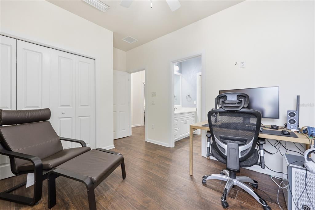 9255 Southwest 29 Avenue Gainesville, FL 32608 - Photo 40 of 79 a view of a workspace with furniture and wooden floor